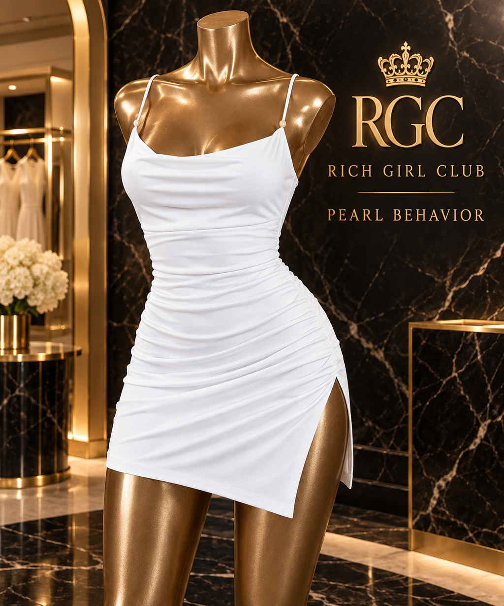 Pearl Behavior white ruched mini dress on a bronze RGC mannequin with a cowl neckline, bead-accented straps and high side slit.