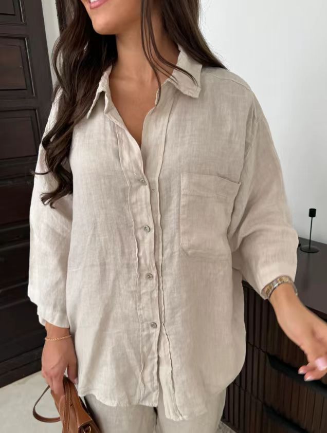 Close front view of the beige button-front shirt with chest pocket and relaxed sleeves.