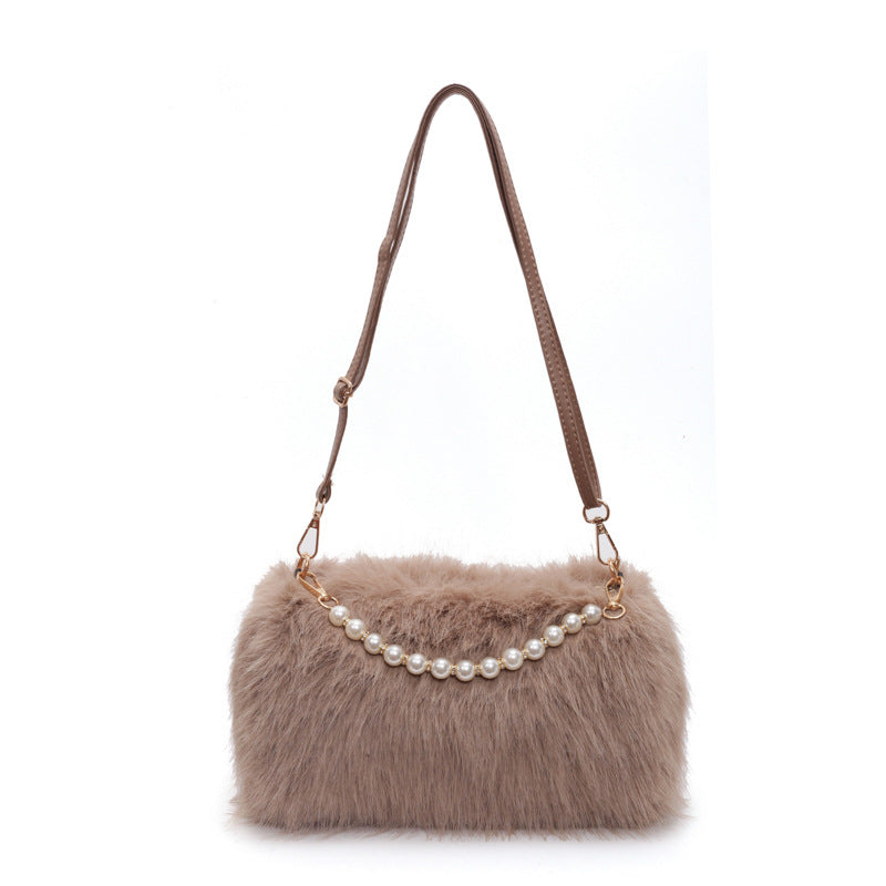 Brown plush shoulder bag with pearl-style front row and adjustable single strap on a white background.