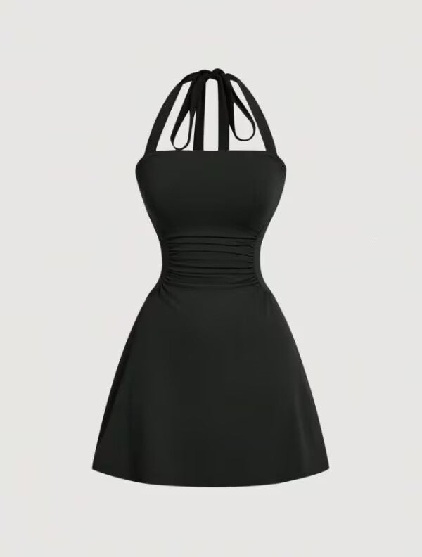 Solid black A-line mini dress with ruched waist and tie-back halter straps, front product view.