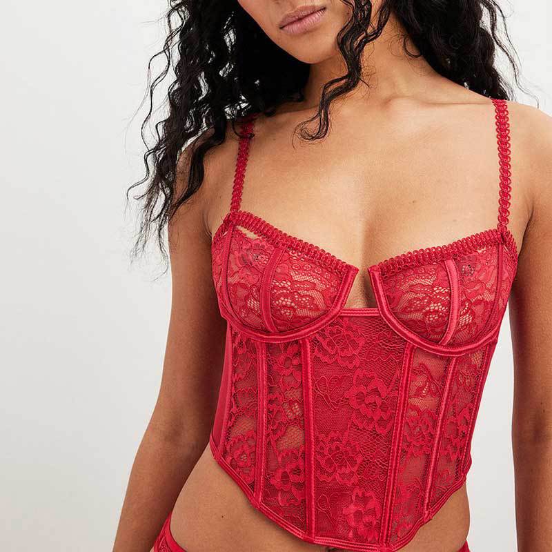 Adult model wearing the red lace corset bra, front view