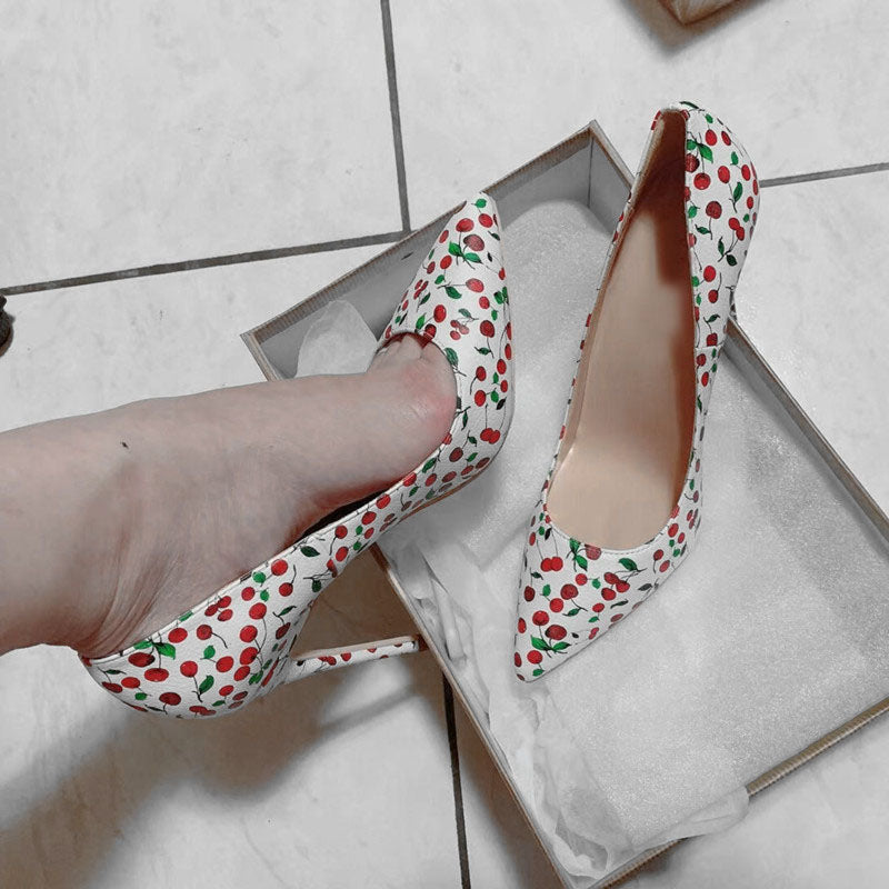 Cherry-print pointed-toe stiletto pumps shown with shoe box