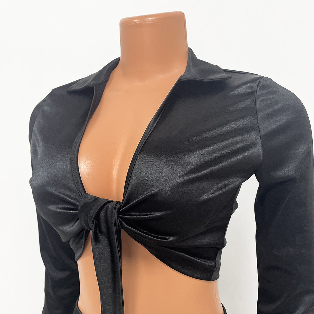 Black satin-look bow-front top and matching mini skirt shown together.