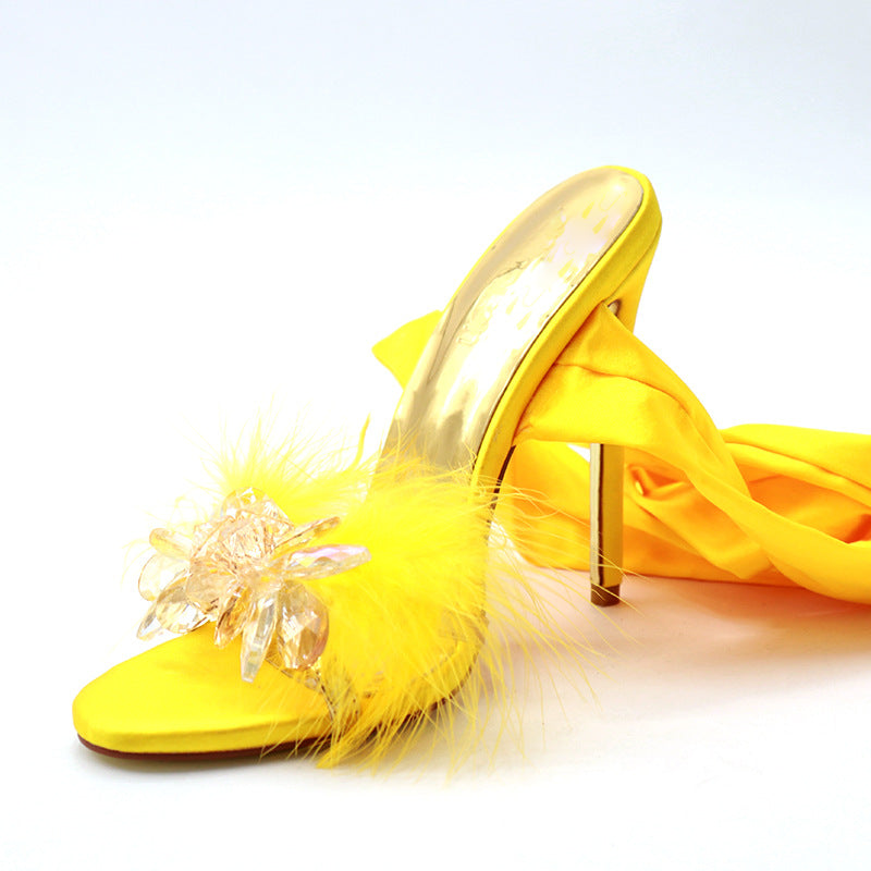 Golden Hour yellow cross-strap stiletto heel, product-only side three-quarter view showing the crystal-flower toe ornament, wrap ribbon, and slim gold heel