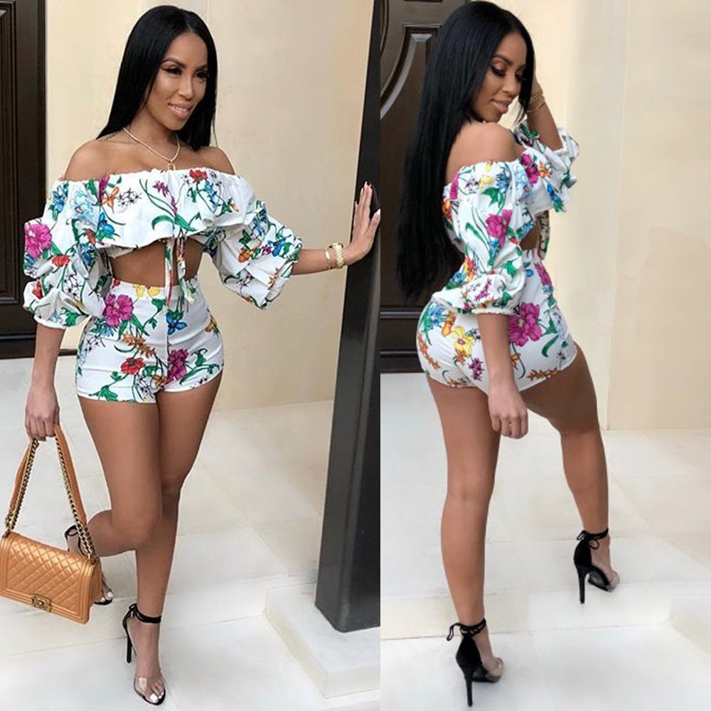 Adult model wearing the white multicolor botanical-print ruffle crop top and matching shorts set, front view.