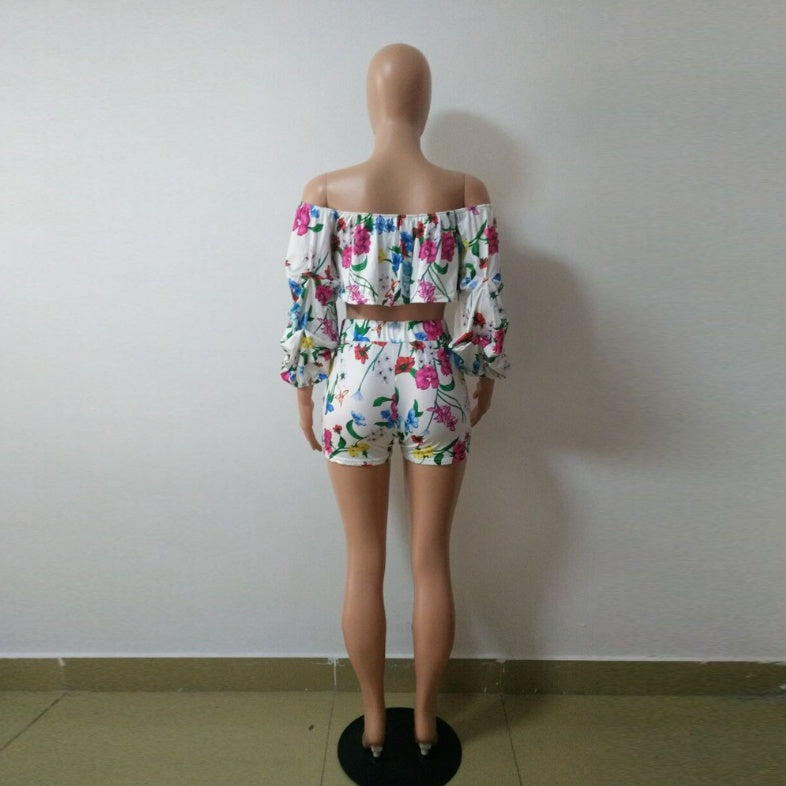 Side view of the white multicolor printed crop top and matching fitted shorts on an adult model.
