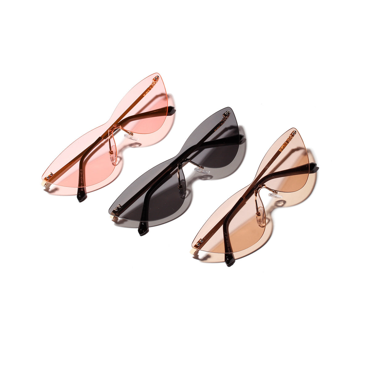 Three rimless cat-eye sunglasses in pink, black and brown arranged on a white background