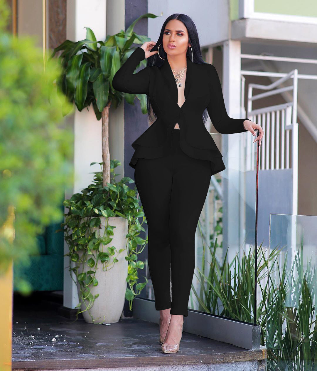 Power Position Peplum Suit view of the long-sleeve deep-V peplum jacket with layered ruffle hem and matching slim trousers (image 1).