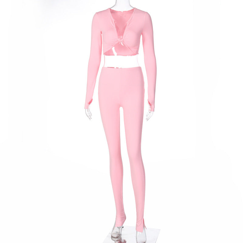 Pink long-sleeve crop top and matching fitted jogger pants shown on a transparent mannequin.
