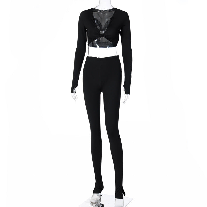 Black long-sleeve crop top and matching fitted jogger pants shown on a transparent mannequin.