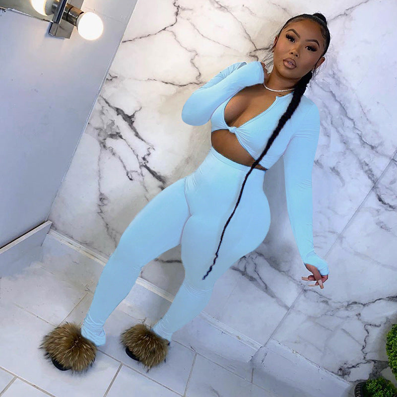 Adult model wearing the blue long-sleeve crop top and matching fitted jogger pants.