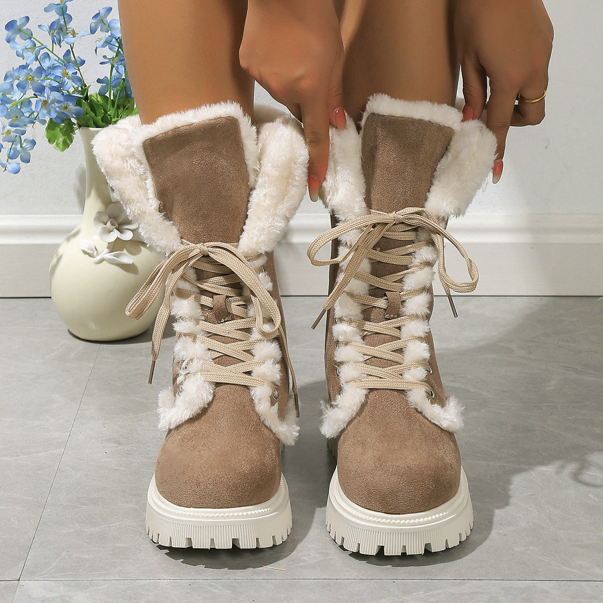 Brown Frost Kiss Lace-Up Boots shown from the front with laces and plush cuffs.