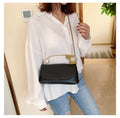 Model wearing the black Power Move Top-Handle Bag with the chain strap
