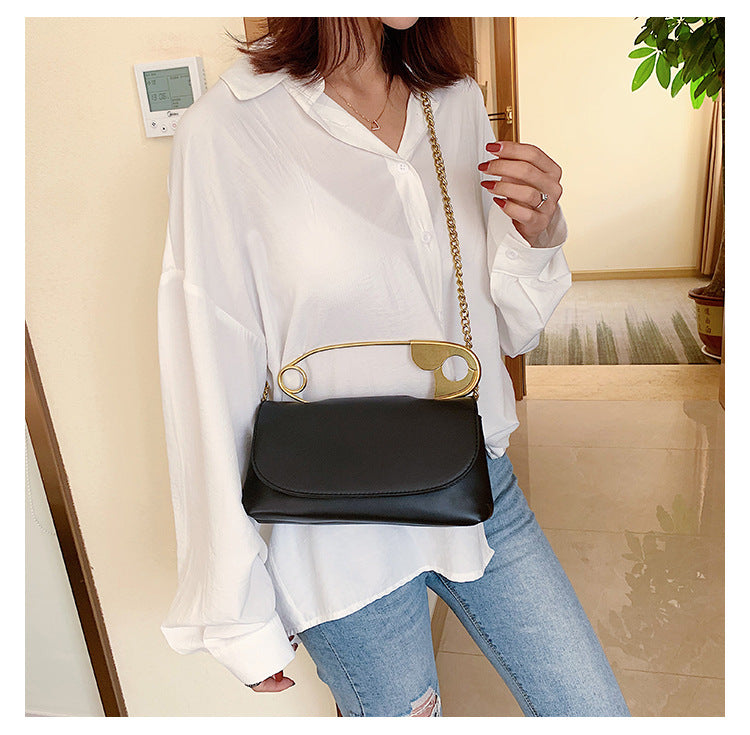 Model wearing the black Power Move Top-Handle Bag with the chain strap