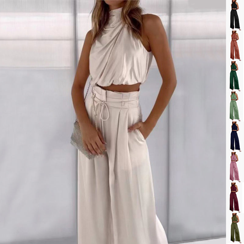 Model wearing the ivory-white draped sleeveless crop top and wide-leg trouser set, with color options shown.