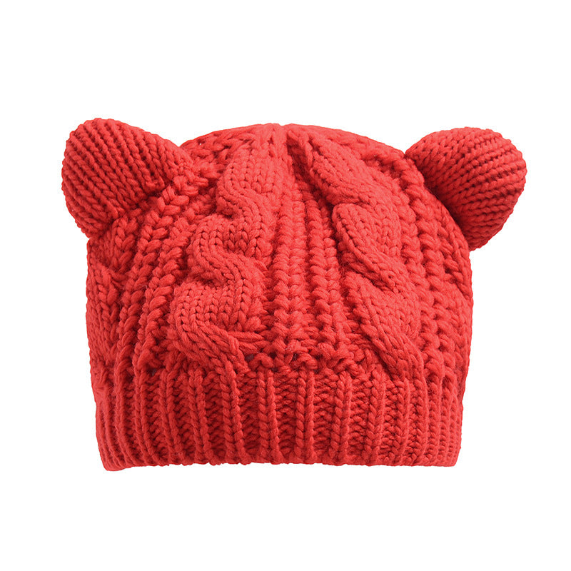 Kitty Club red cat-ear cable-knit beanie on a model