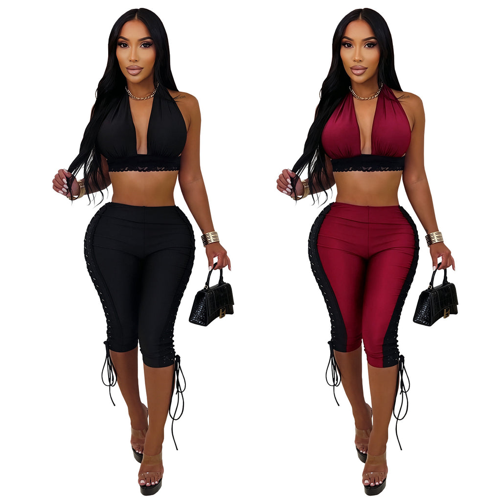Models wearing black and wine-red After Hours halter crop-top and lace-up capri-pants sets, front view on white background