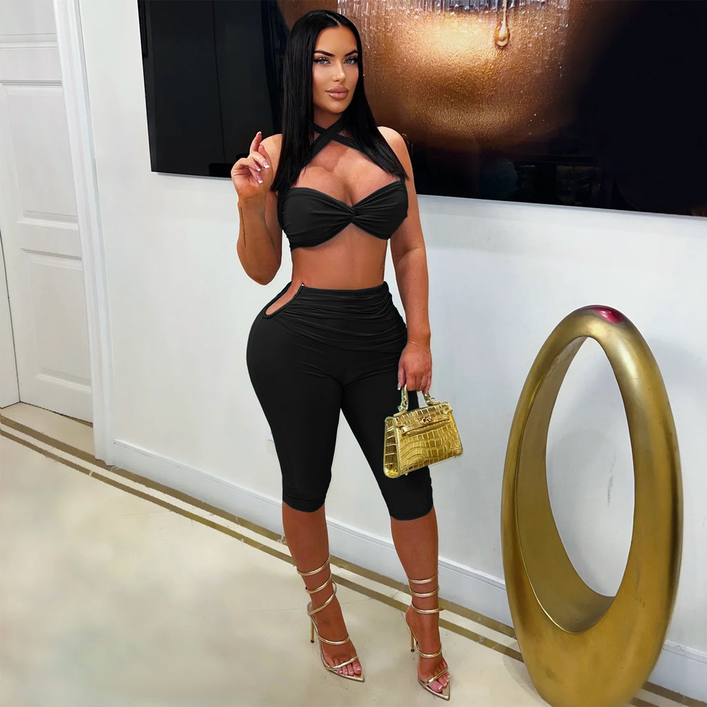 All Tied Up black cross-halter crop top and matching fitted shorts on model
