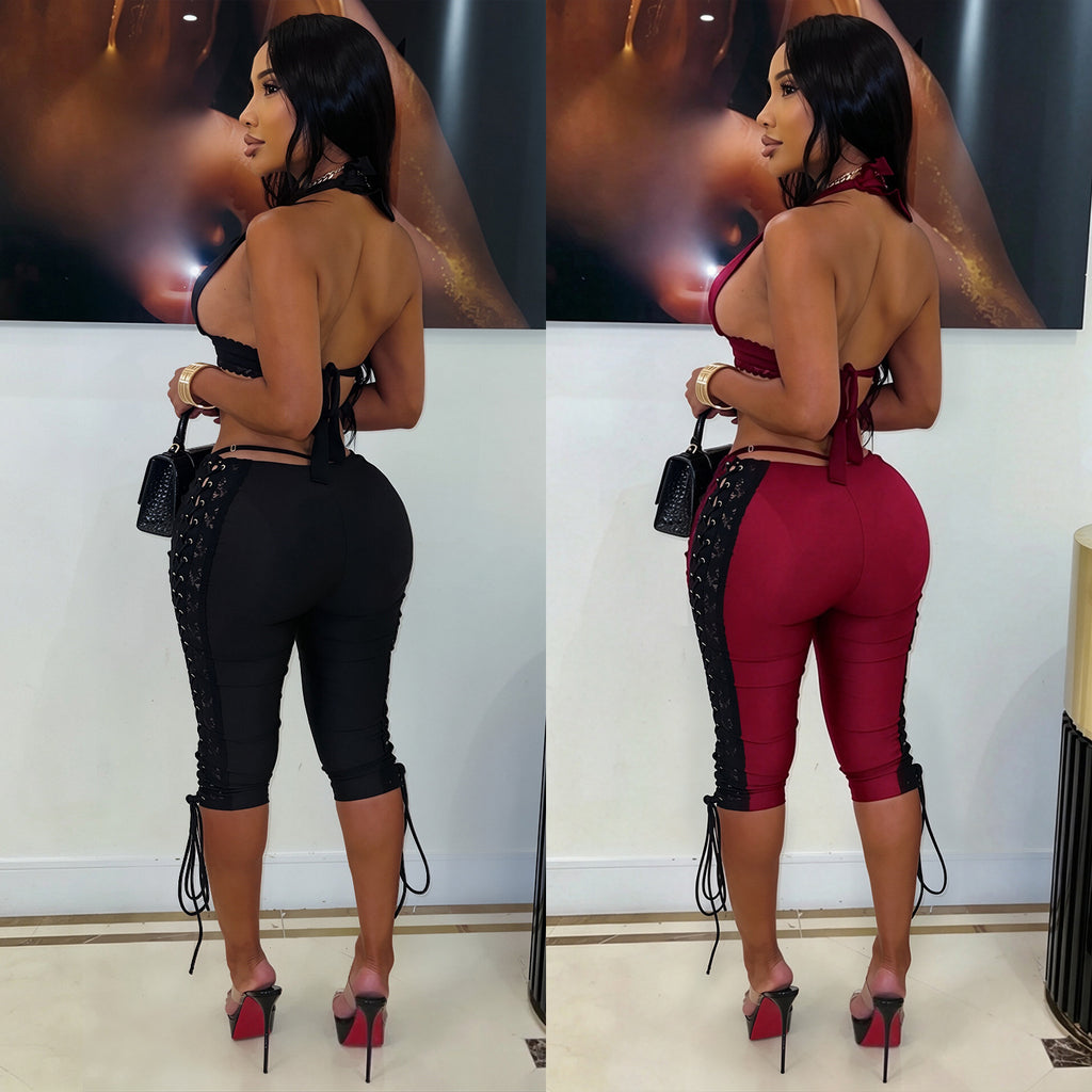 Models wearing After Hours halter crop-top and lace-up capri-pants set in black and wine red, back view