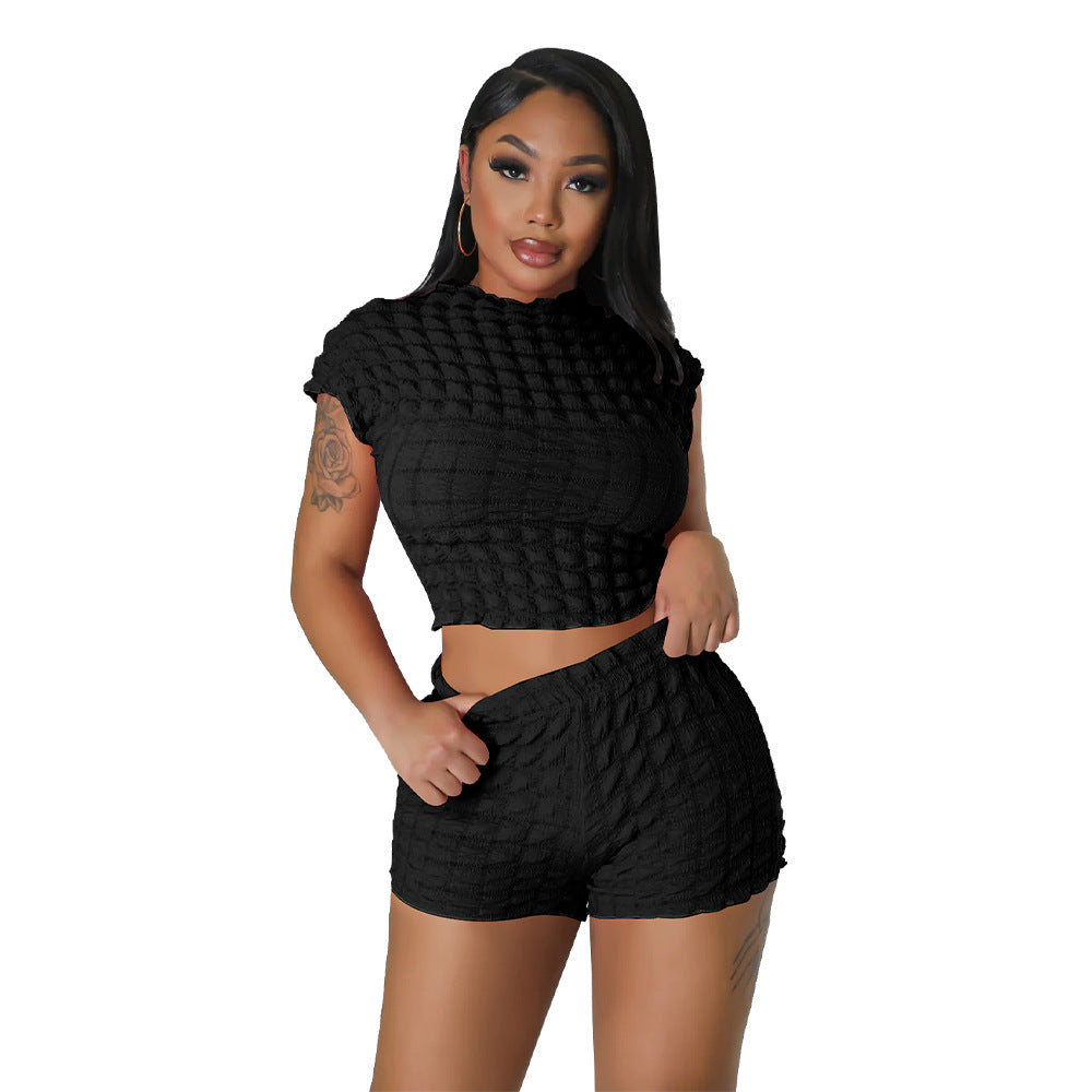 Adult model wearing the black bubble-texture crop top and matching shorts, front cutout view.