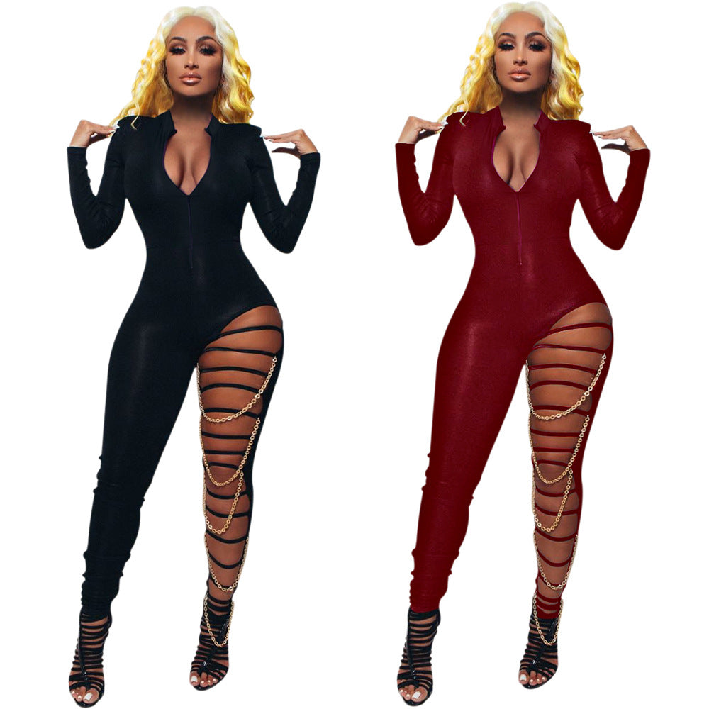 Side-by-side adult-model views of the black and red deep-V zip-front Chain Reaction jumpsuits with strapped leg cutouts and gold-tone chain drapes.