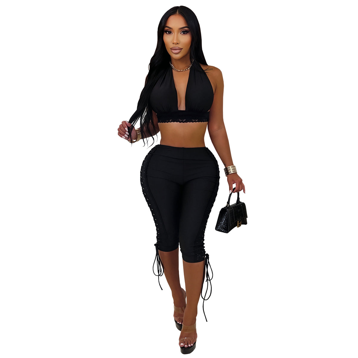Model wearing black After Hours halter crop top and matching lace-up capri pants, front view on white background