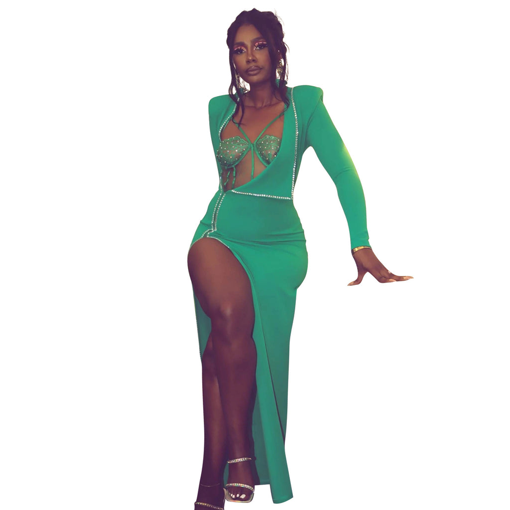Front view of a model wearing the green Billion Moves Maxi Dress with long sleeves, jeweled cutout bodice, and high thigh slit.