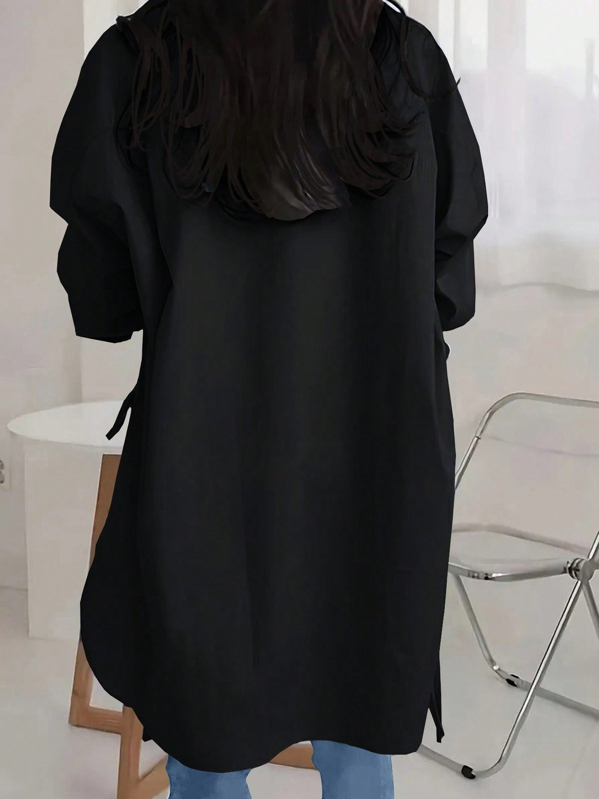 Back view of the black Off-Duty Luxe longline shirt with curved hem