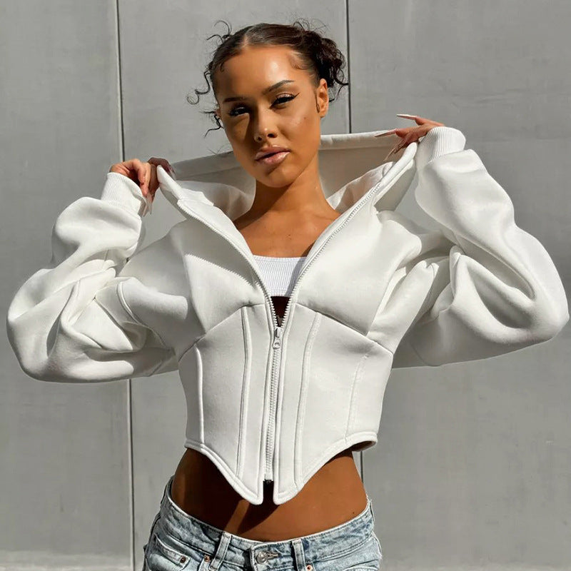 Adult model wearing the white zip-front cropped hoodie with corset-style seams and pointed front hem.