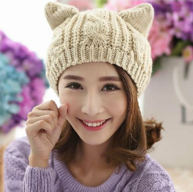 Kitty Club beige cat-ear cable-knit beanie on a model