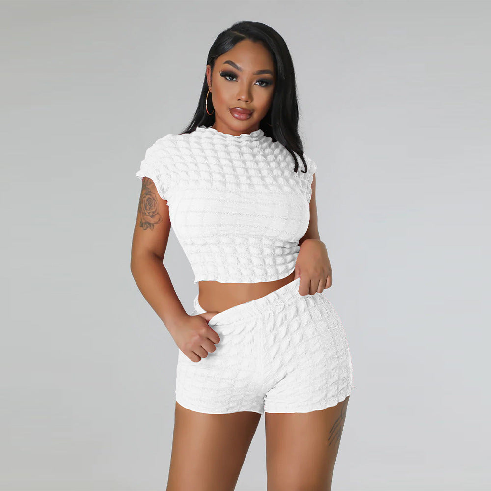 Adult model wearing the white bubble-texture crop top and matching shorts, front view on a gray background.