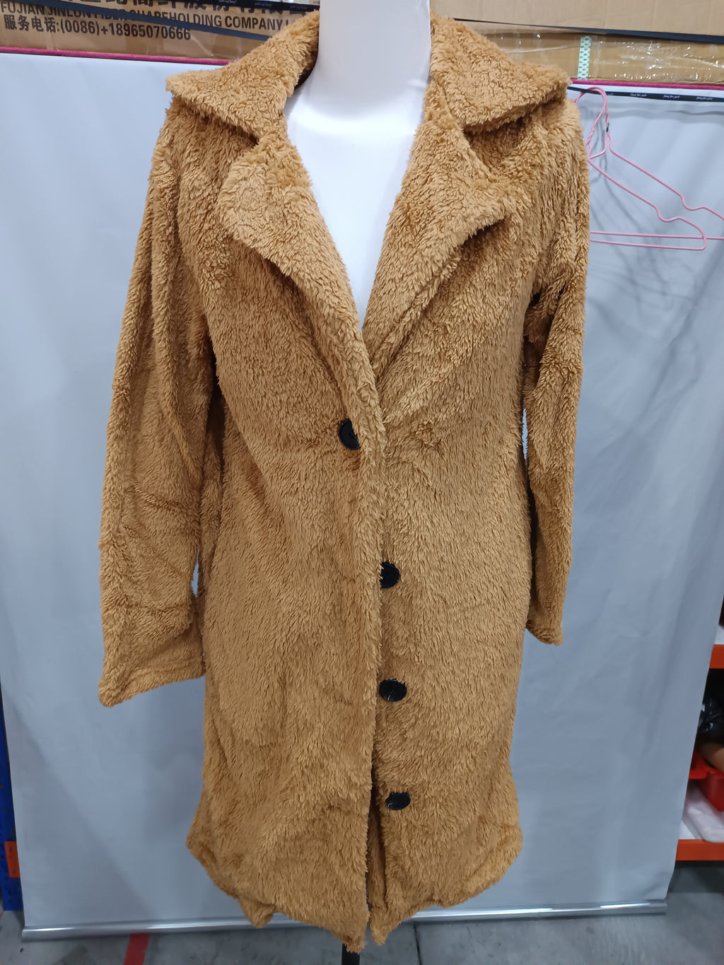 Camel plush longline jacket on a mannequin, front view showing lapels and black buttons.