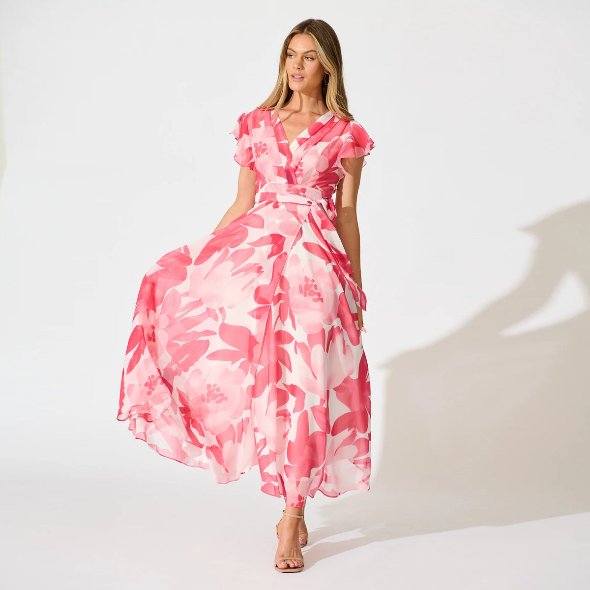 Petal Waltz peach botanical maxi dress with flutter sleeves and flowing A-line skirt
