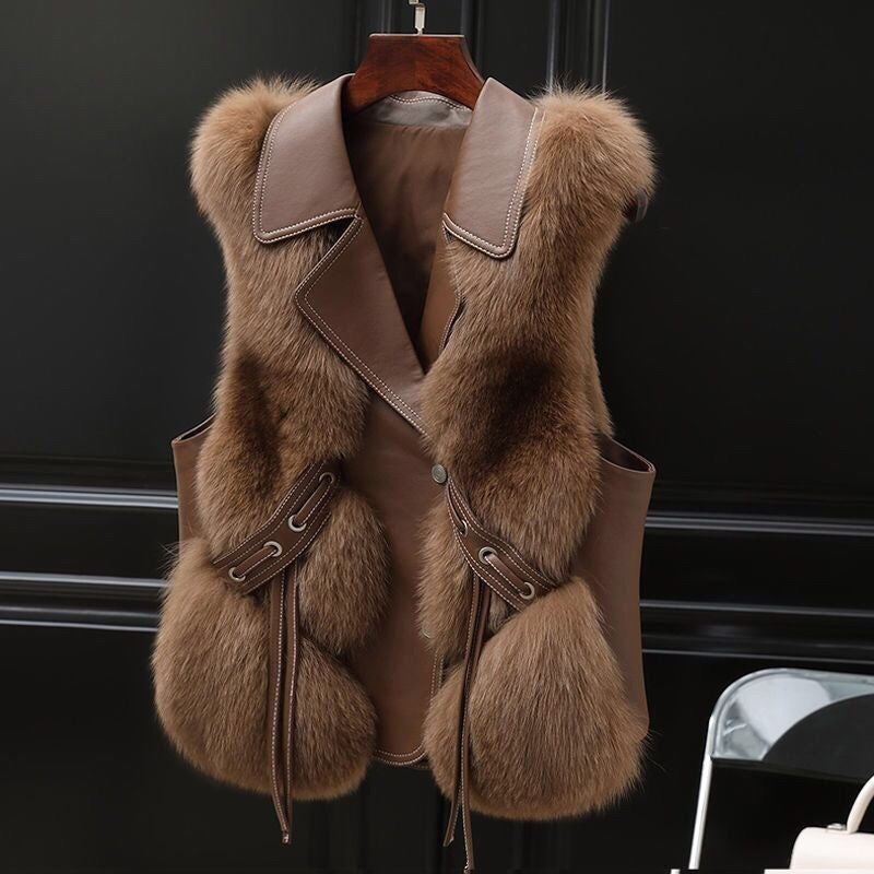 Camel Soft Power Faux-Fur Vest front view on a wooden hanger, showing wide lapels, button front, pockets, and tie accents.