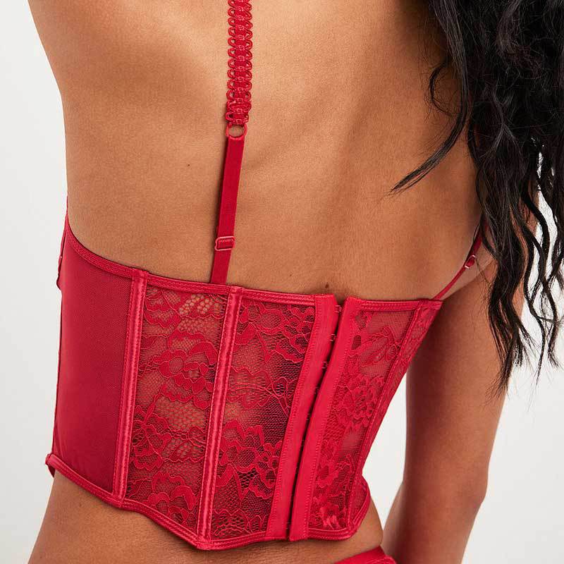 Adult model wearing the red lace corset bra, back view