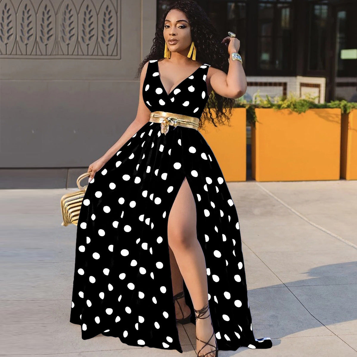 Adult model wearing the black-and-white polka-dot V-neck maxi dress; belt and accessories are styling only.