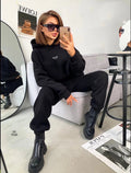 Black Soft Life hooded lounge set seated front view
