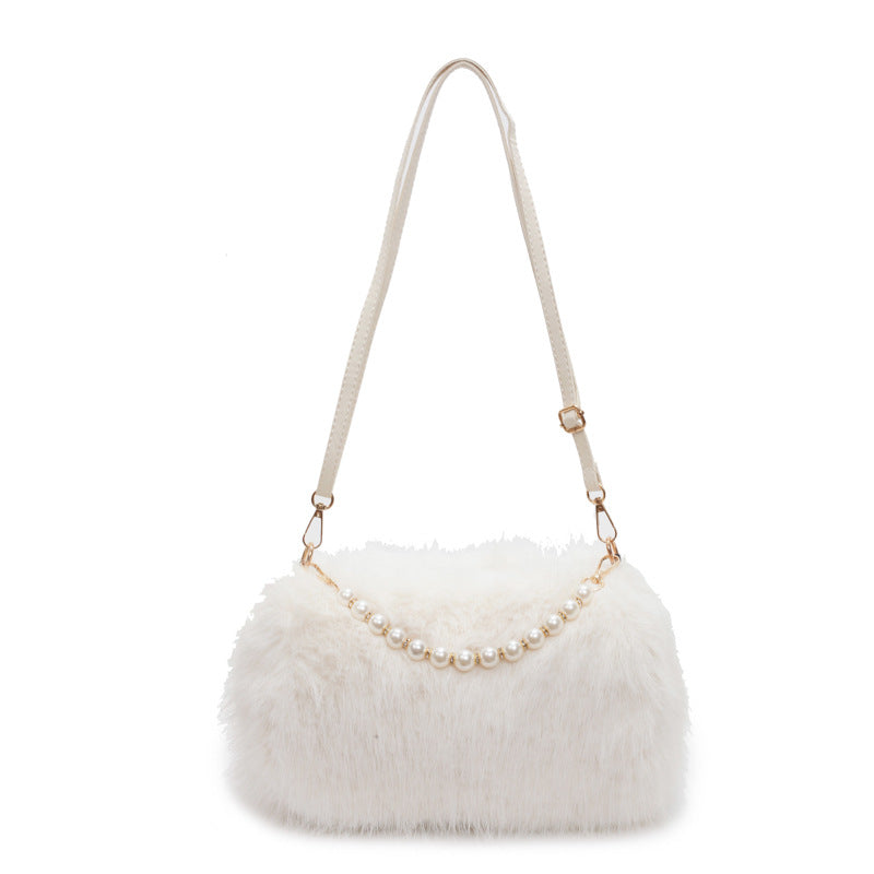 White plush shoulder bag with pearl-style front row and adjustable single strap on a white background.