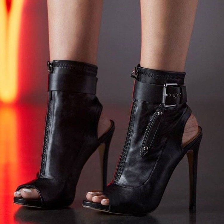 Black After Dark Cutout Stiletto Sandals worn close up showing the open toe and front zipper