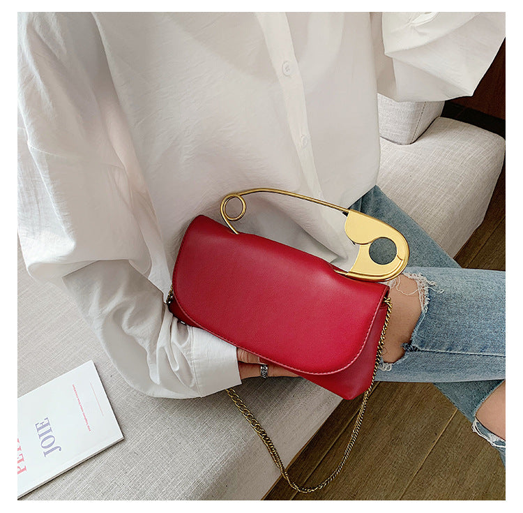Red Power Move Top-Handle Bag held by its gold-tone handle, styled on a model