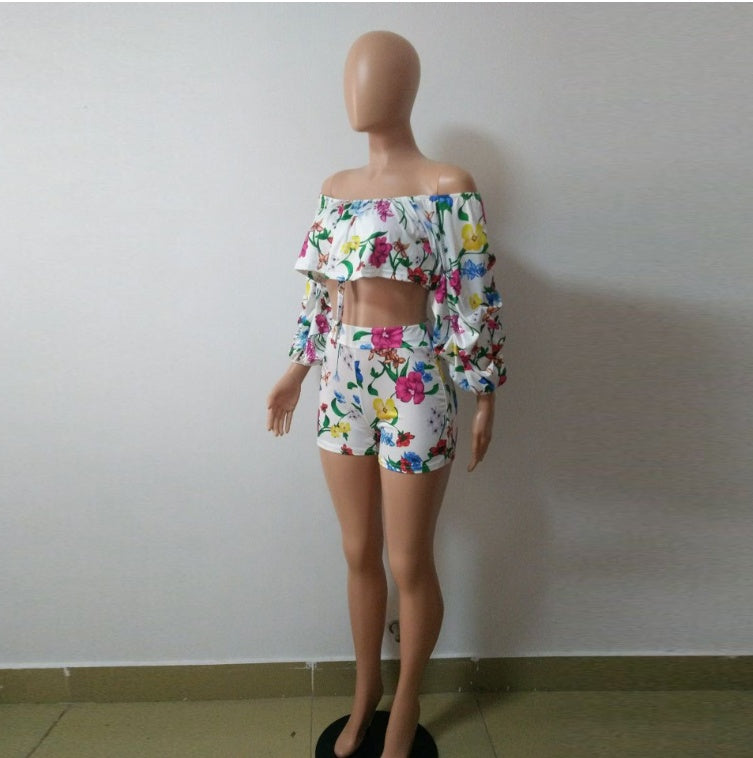 Close front view of the botanical-print ruffle crop top, gathered sleeves, tie and matching shorts.
