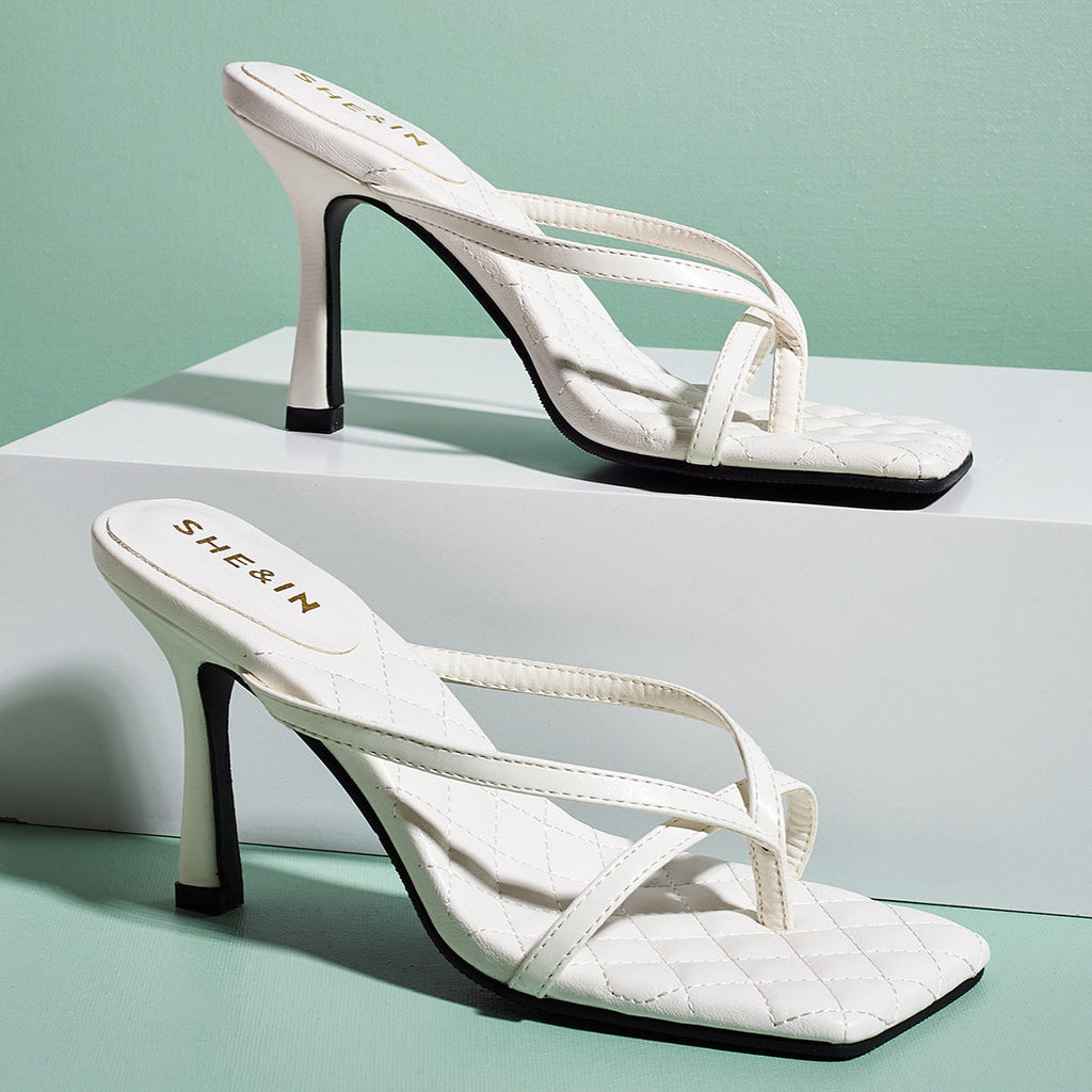 White square-toe sculpted strap mule heels shown as a pair