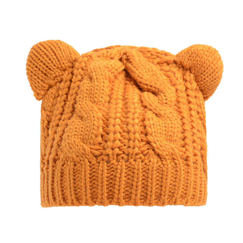 Kitty Club yellow cat-ear cable-knit beanie on a model
