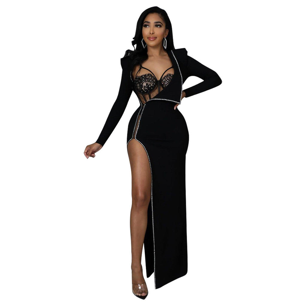 Front view of a model wearing the black Billion Moves Maxi Dress with long sleeves, jeweled sheer bodice, rhinestone trim, and high thigh slit.