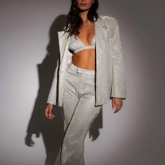 Adult model wearing the silver sequin bra, matching tailored jacket, and trousers set, front view.