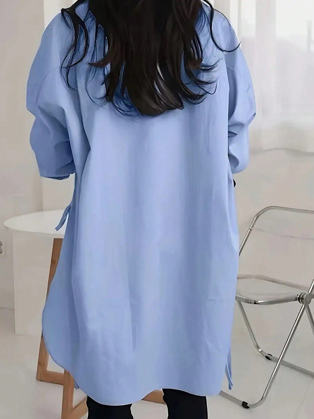 Back view of the blue Off-Duty Luxe longline shirt with curved hem