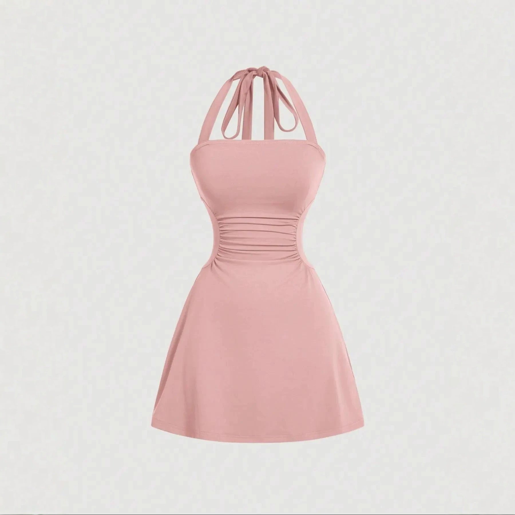 Solid blush-pink A-line mini dress with ruched waist and tie-back halter straps, front product view.