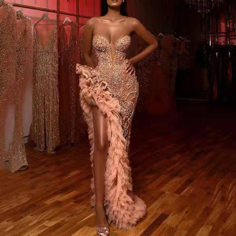 Front close view of Champagne Drama Sequin Gown with strapless crystal corset and blush feathered high-slit drape