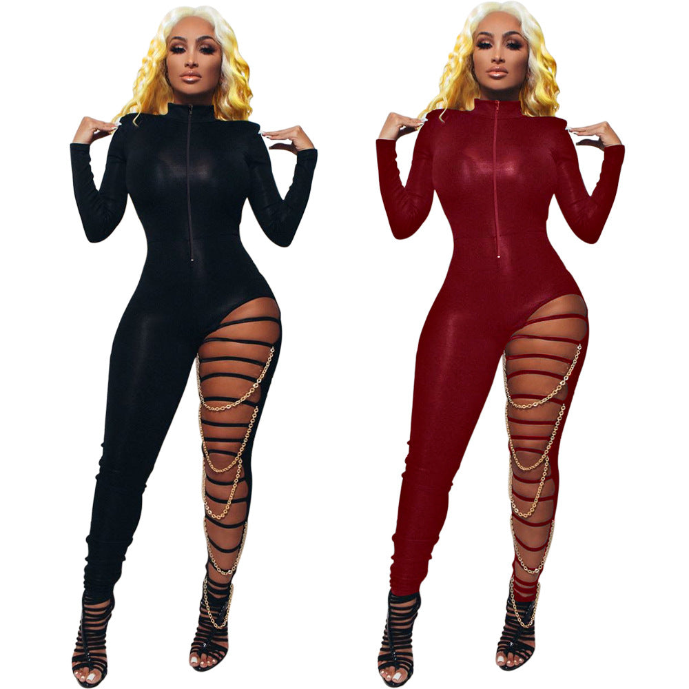 Side-by-side adult-model views of the black and red high-neck zip-front Chain Reaction jumpsuits with strapped leg cutouts and gold-tone chain drapes.