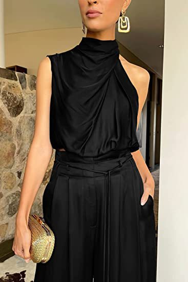 Close front view of the black draped high-neck crop top with matching pleated tie-waist trousers.